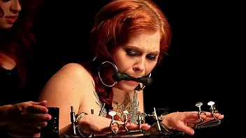 Gagged Redhead Babe In Bondage Device Gets Spanked
